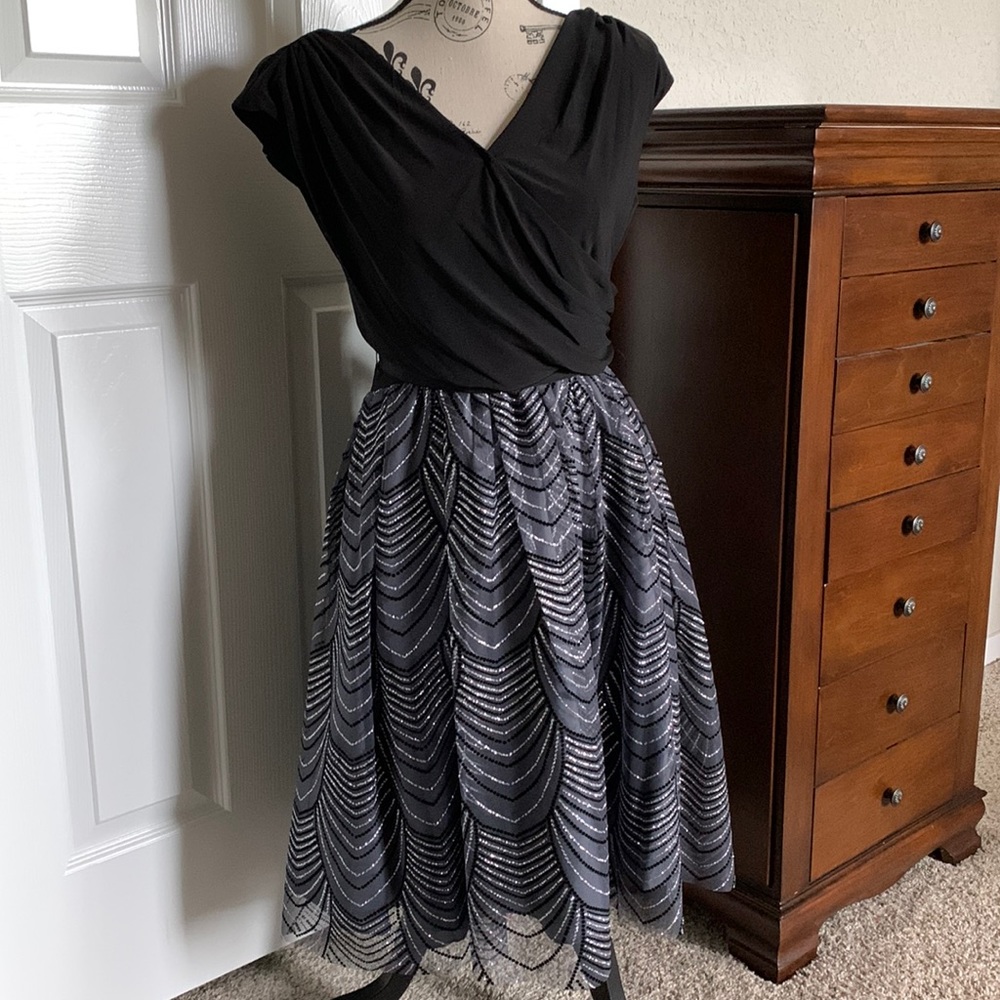 Cocktail dress. Black with silver sparkles throughout skirt.